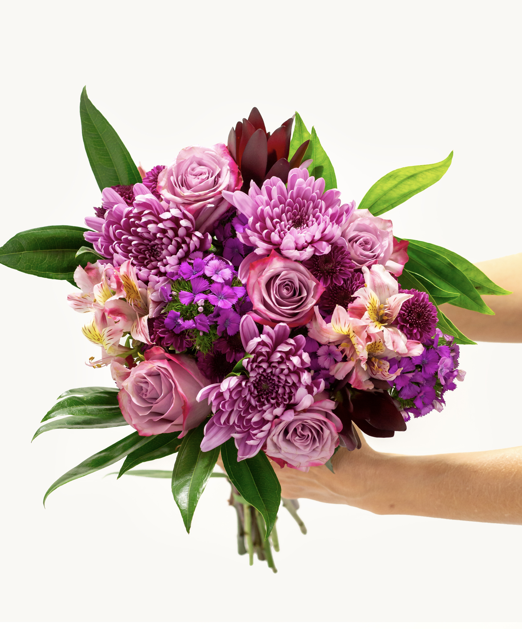 Vibrant bouquet featuring purple roses, chrysanthemums, and lush greenery, perfect for any occasion.