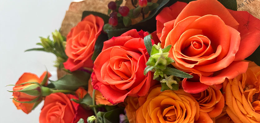 Vibrant orange and yellow roses arranged elegantly, perfect for celebrations and special moments.