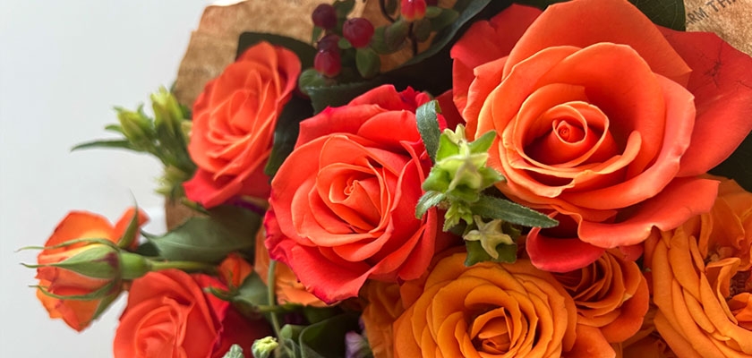 Vibrant orange and yellow roses arranged elegantly, perfect for celebrations and special moments.