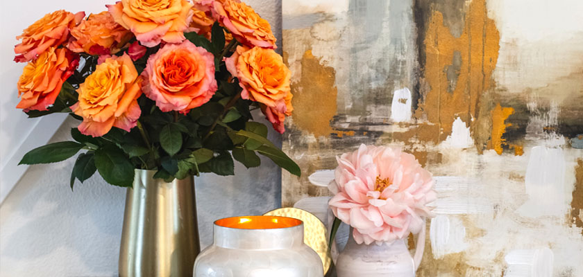 Vibrant peach roses artfully arranged in elegant vases, complementing modern decor.