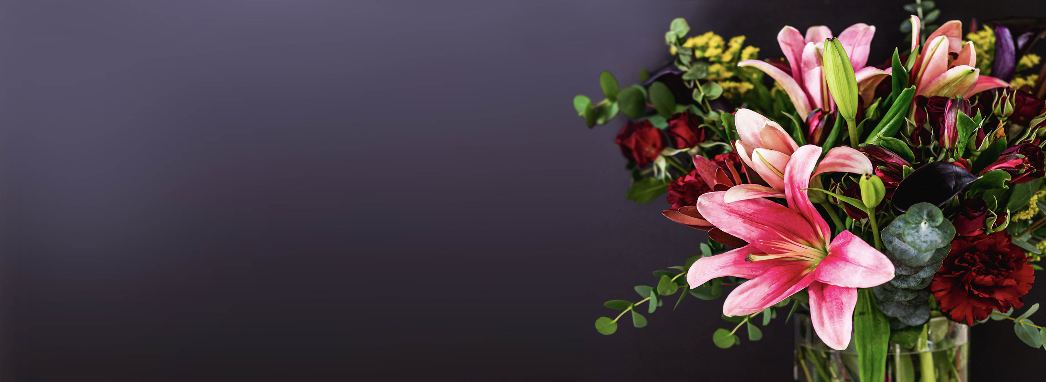 Vibrant floral arrangement featuring pink lilies and lush greenery, ideal for sophisticated decor.