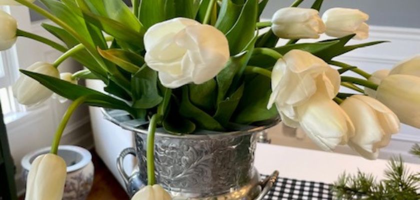 Elegant white tulips in a classic silver vase, adding sophistication to any space.