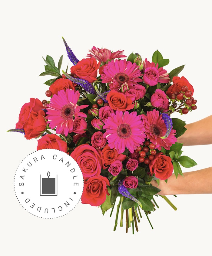 Vibrant floral bouquet featuring pink gerbera daisies and red roses, perfect for celebrations.