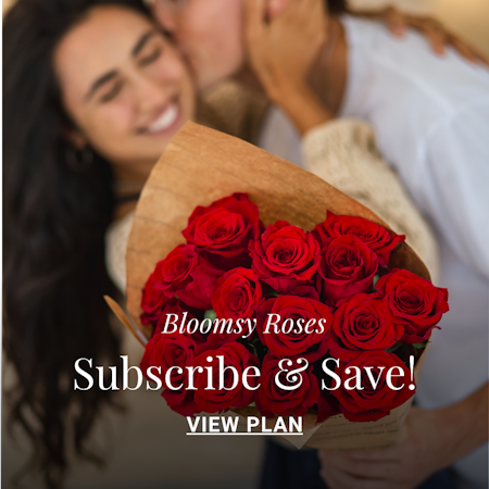 A romantic couple sharing a joyful moment with a bouquet of red roses.