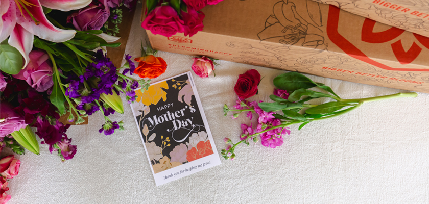 A vibrant Mother&#x27;s Day floral arrangement with a heartfelt card and colorful blooms.