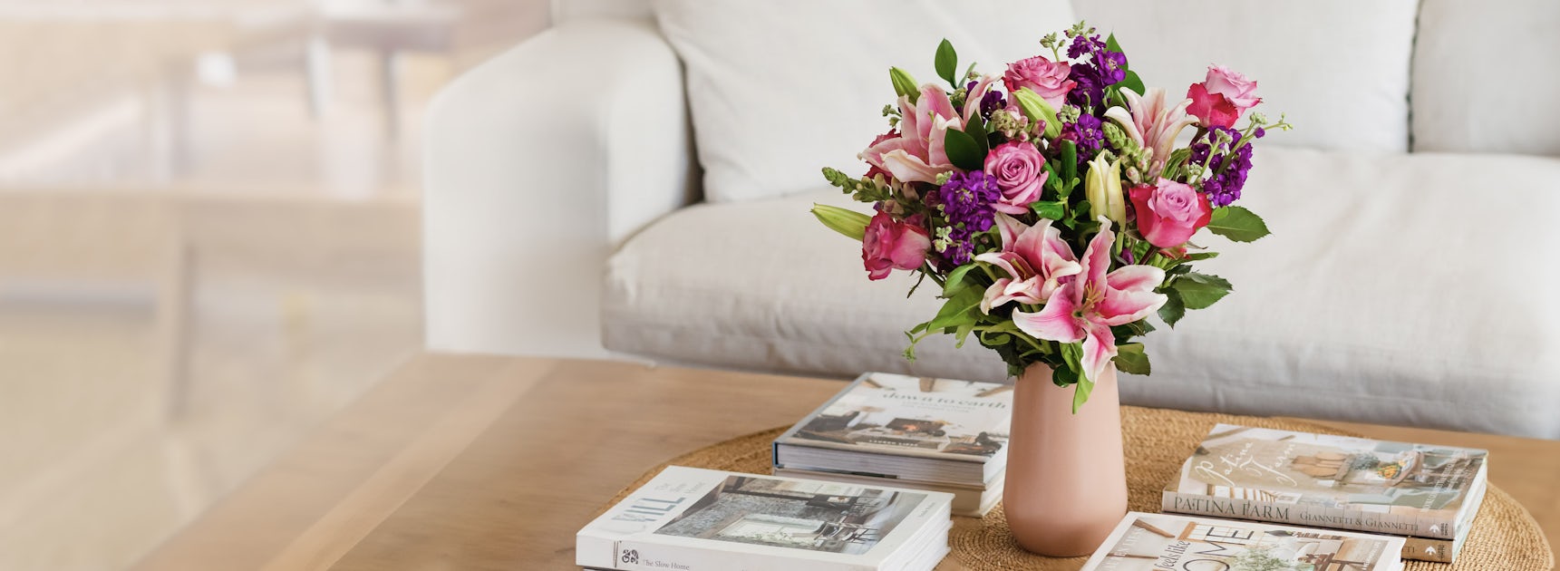 Vibrant floral arrangement featuring pink roses and lilies, elegantly displayed in a modern vase.