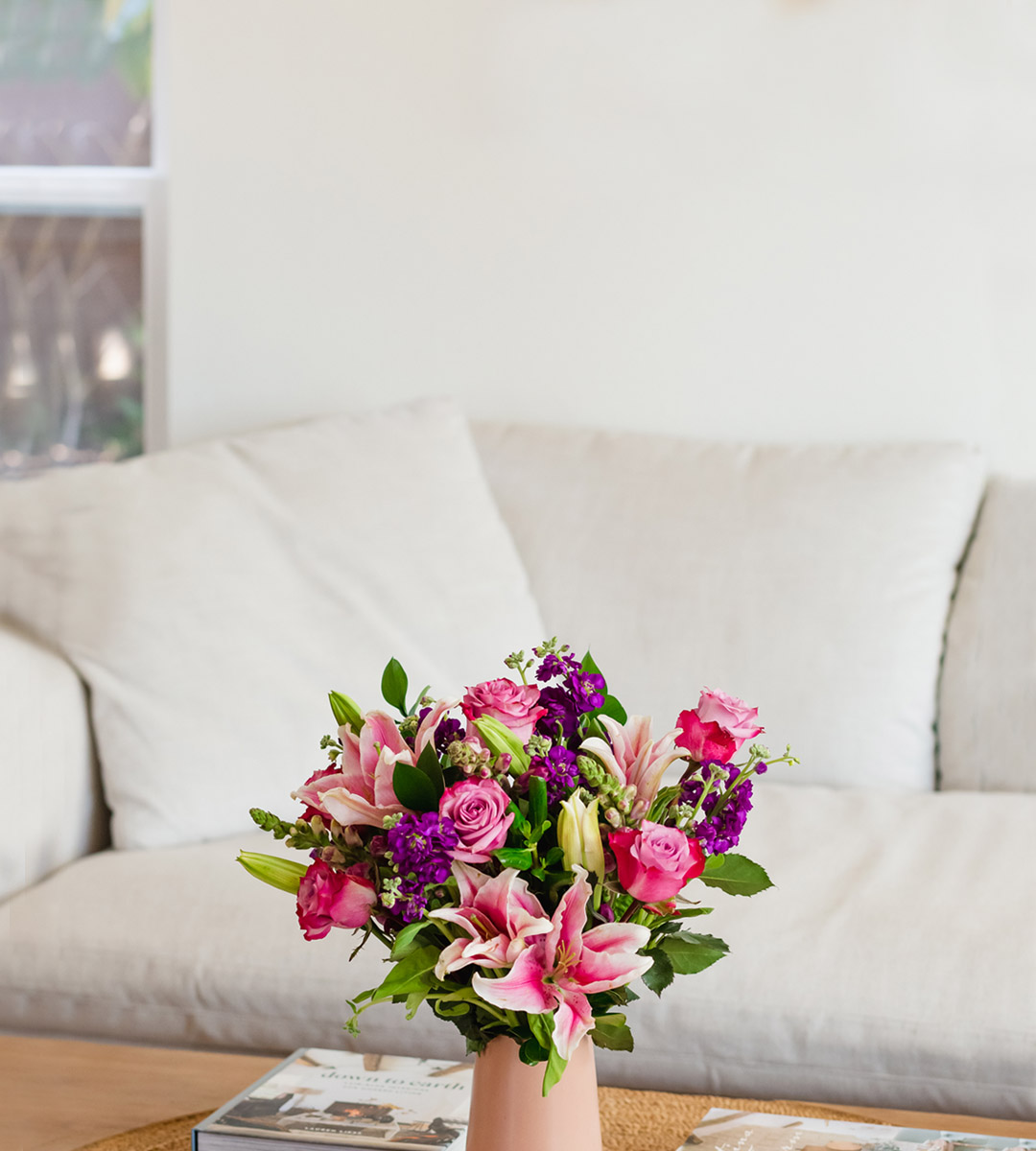 Charming floral arrangement featuring pink lilies and roses in a stylish vase, enhancing home decor.