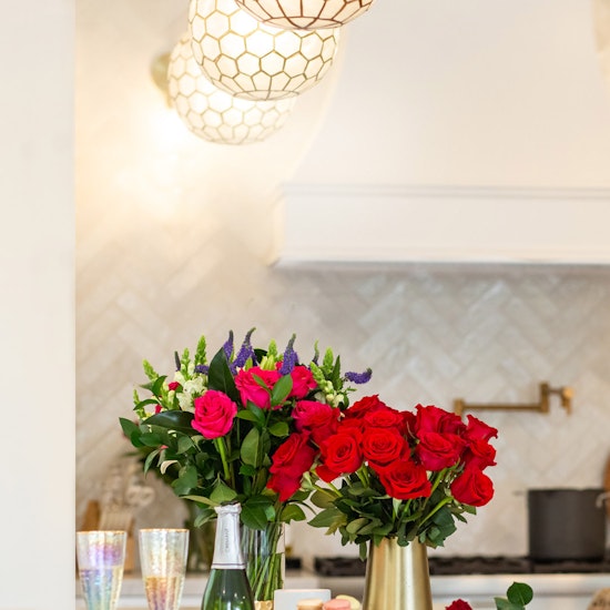 Vibrant floral arrangements featuring red and pink roses in elegant vases, enhancing home decor.