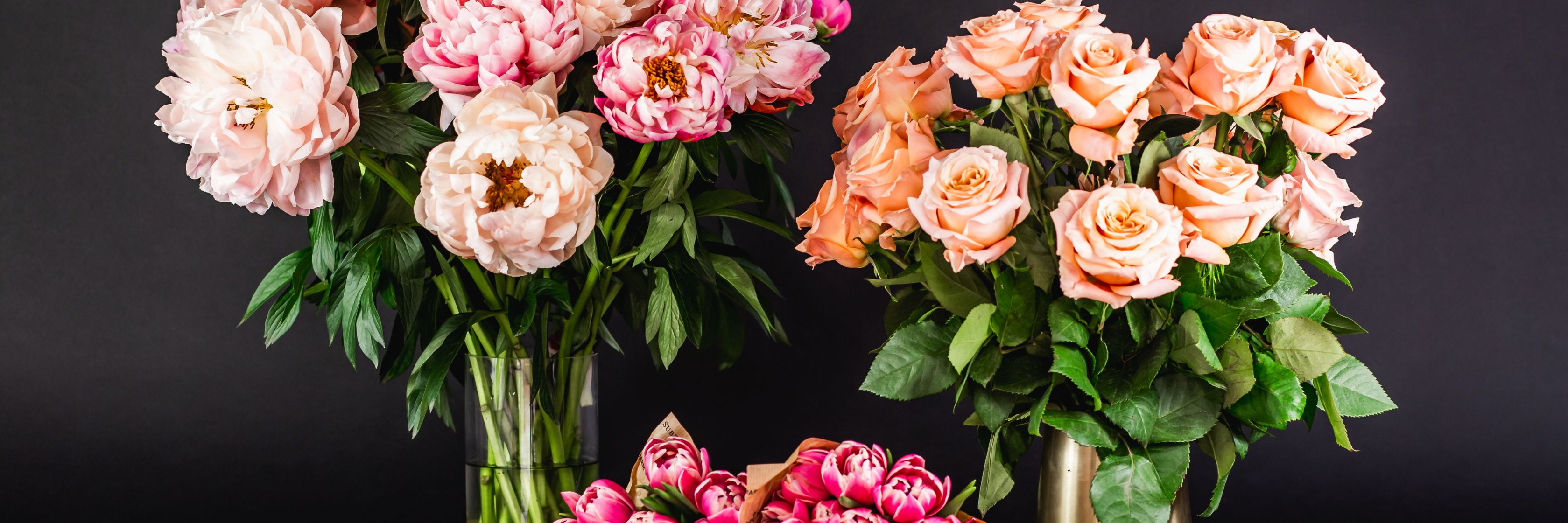 Beautifully arranged peony and rose bouquets against a dark backdrop, perfect for elegant decor.