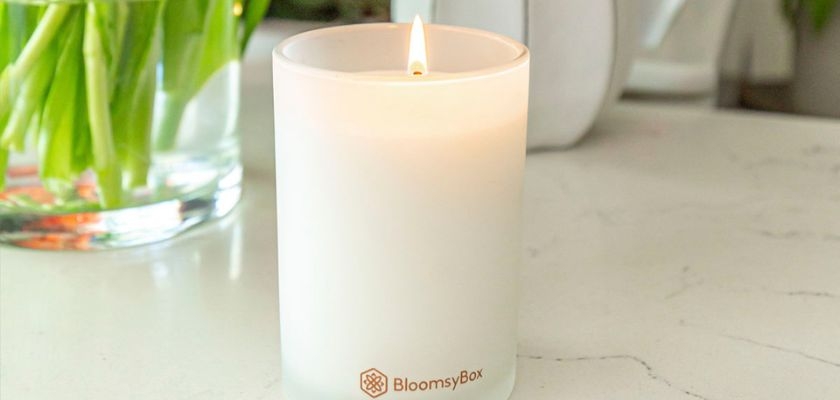 A soothing candle from BloomsyBox, gently illuminating a serene space, perfect for relaxation.