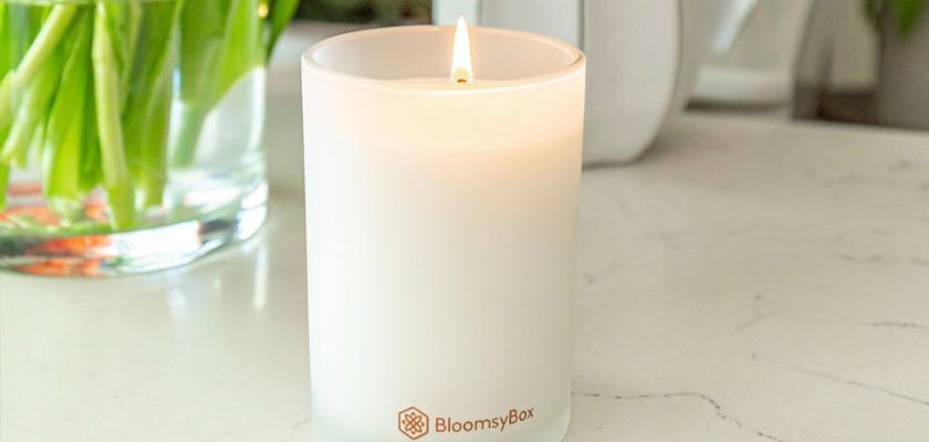 A soothing candle from BloomsyBox, gently illuminating a serene space, perfect for relaxation.