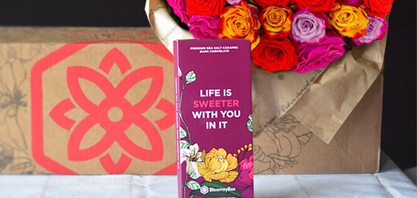 A vibrant floral arrangement of roses paired with gourmet chocolate, ideal for gifting.