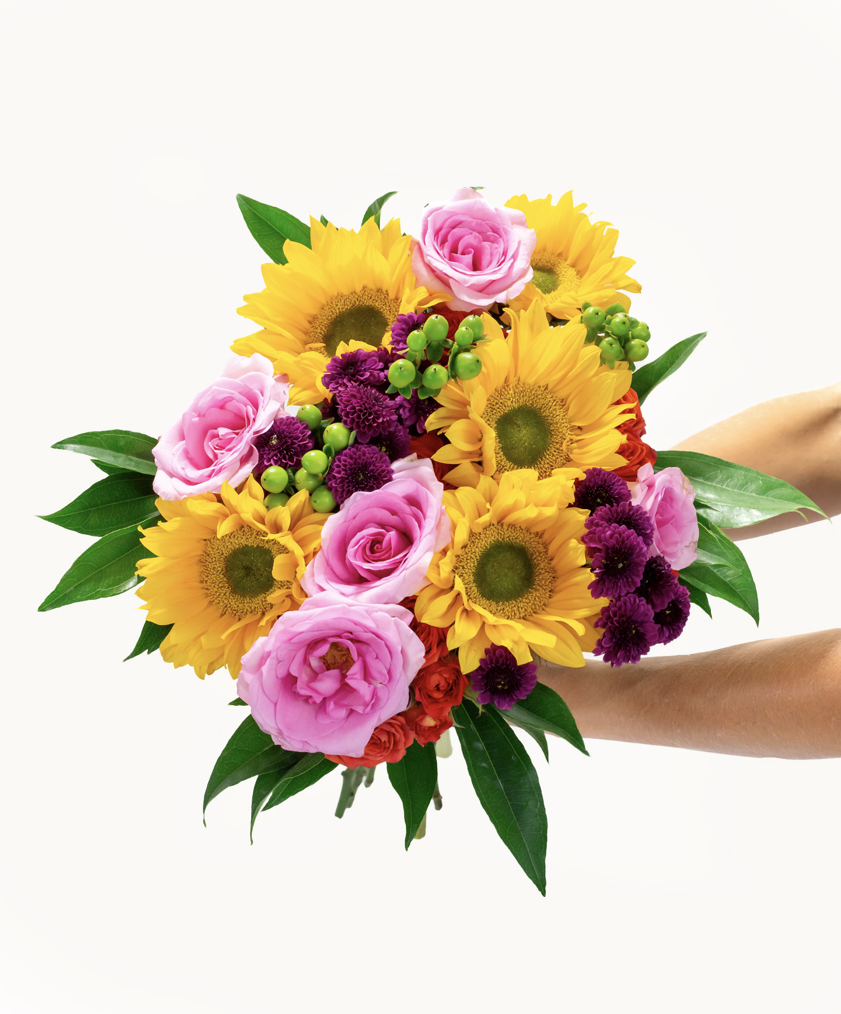 Bright bouquet featuring vibrant sunflowers, pink roses, and purple asters for any celebration.
