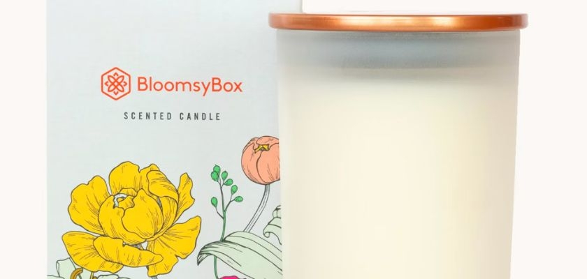 Elegant scented candle in a decorative BloomsyBox container, enhancing any room's ambiance.