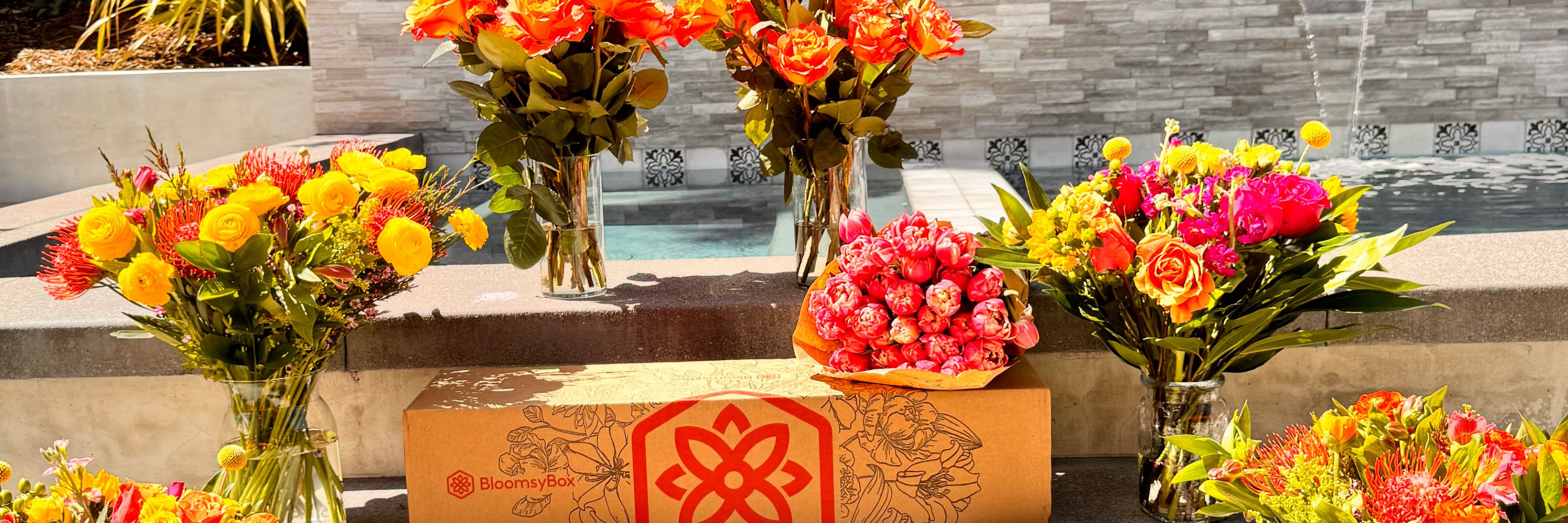 Vibrant floral display featuring assorted roses and colorful blooms arranged beautifully outdoors.