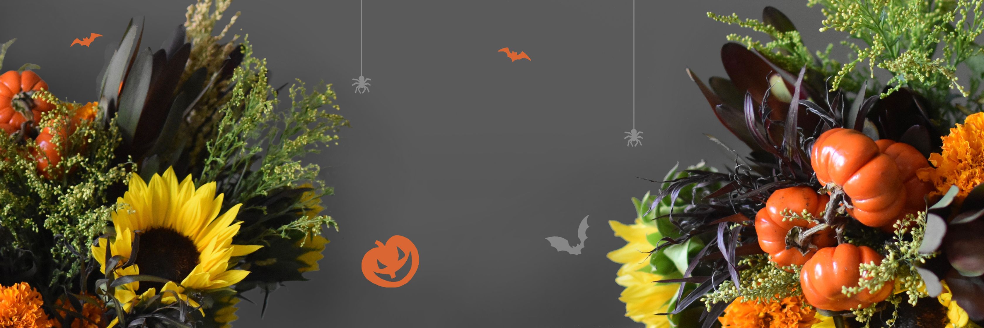 Vibrant autumn floral arrangement featuring sunflowers, marigolds, and mini pumpkins for Halloween.