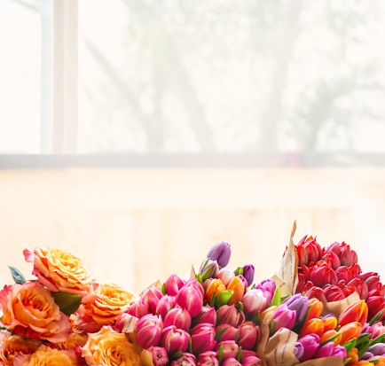 Vibrant floral arrangement featuring colorful tulips and roses, perfect for brightening any space.