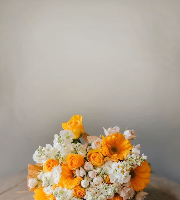 Bright and cheerful bouquet with yellow roses, gerberas, and white blooms, ideal for celebrations.