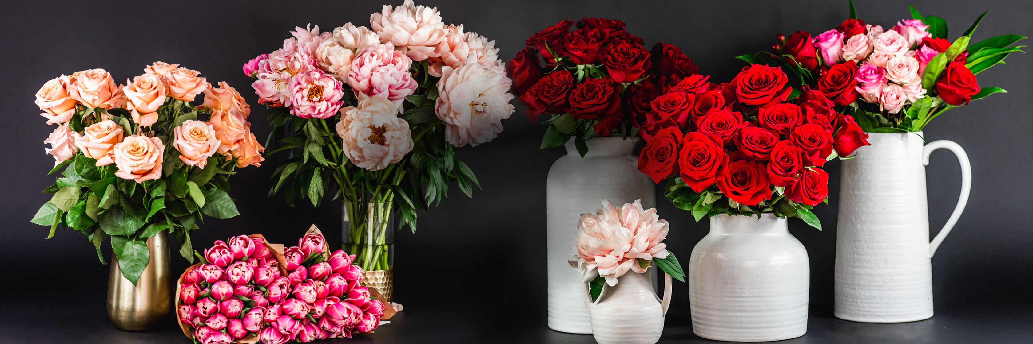 Vibrant floral display featuring pink and red roses in elegant vases, perfect for any occasion.
