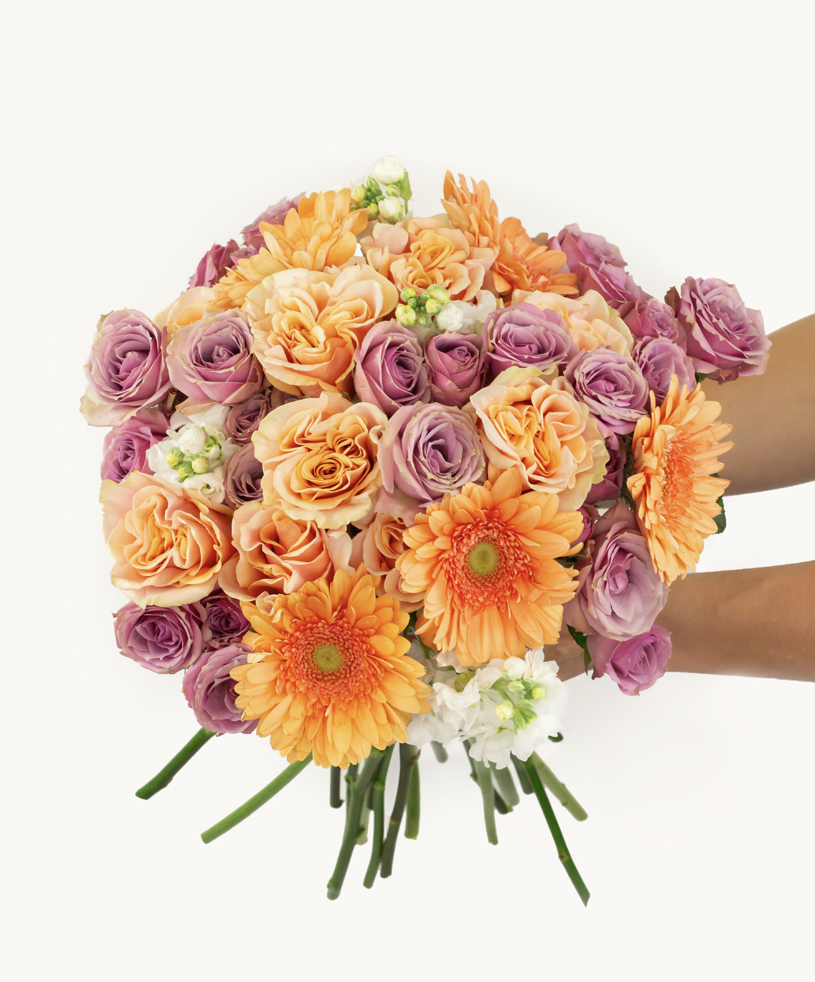 Vibrant bouquet featuring orange gerbera daisies, pink and peach roses, perfect for any celebration.