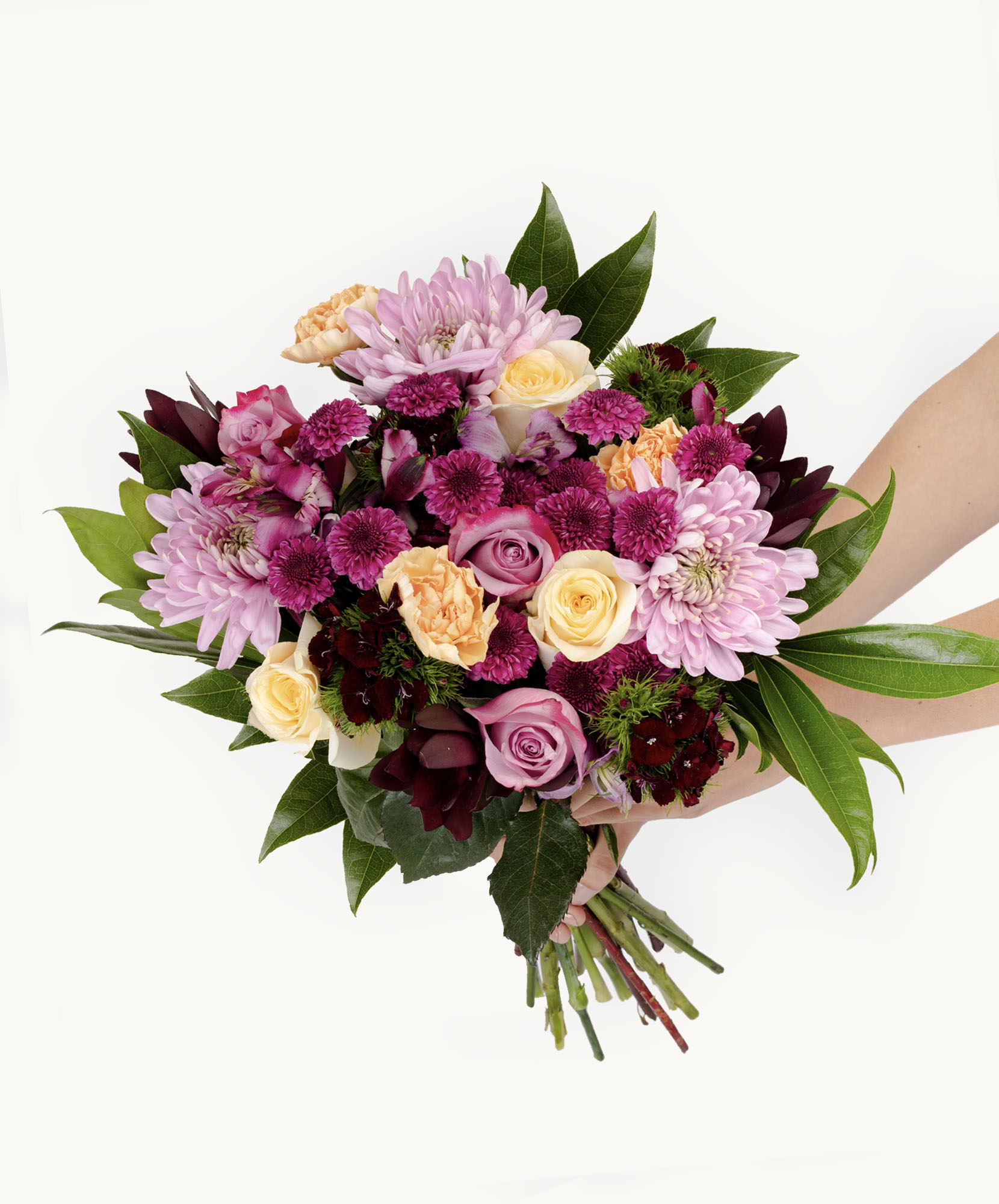 Vibrant bouquet featuring purple and peach roses, combining lush greenery and delicate blooms.