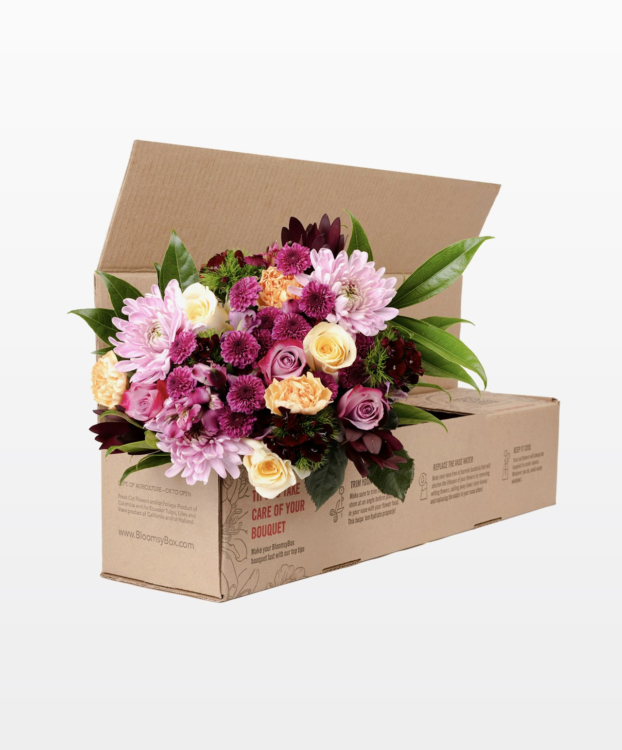 Vibrant floral arrangement featuring pink, purple, and white blooms in a delivery box.