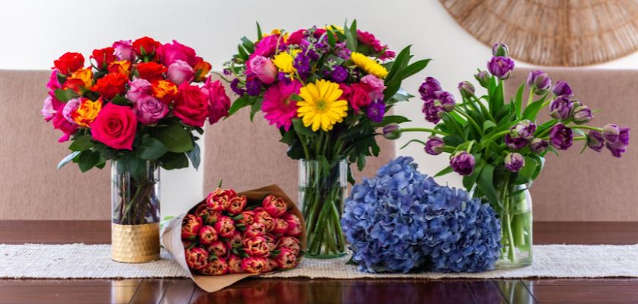 Vibrant floral arrangements featuring roses, tulips, and daisies in elegant vases, perfect for any occasion.