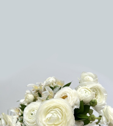Elegant white roses and delicate blooms inspire a serene, tranquil floral arrangement.