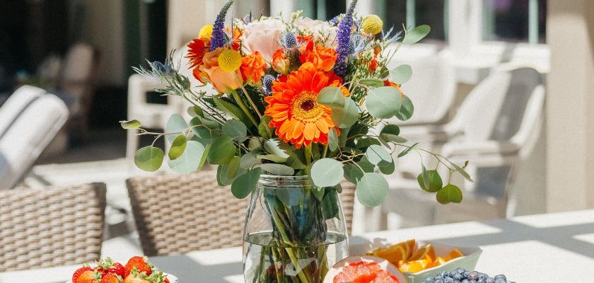 Vibrant floral arrangement featuring gerbera daisies and seasonal blooms in a glass vase.