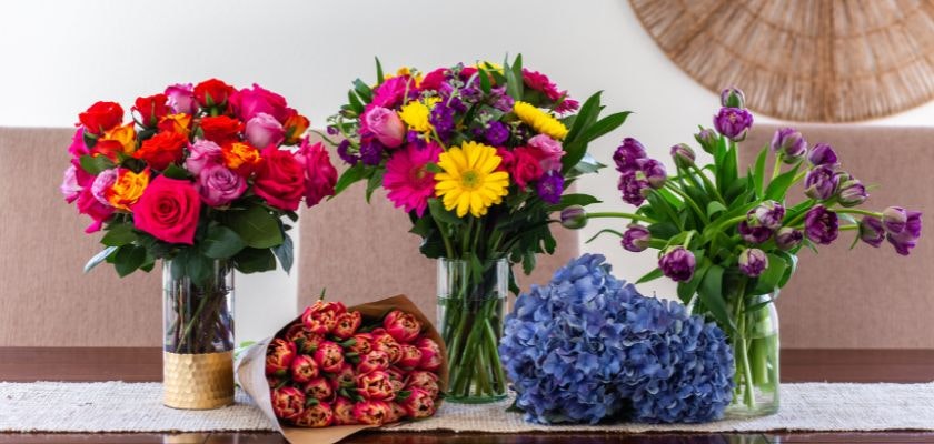 Vibrant flower arrangements featuring roses, tulips, and gerbera daisies in stylish vases.