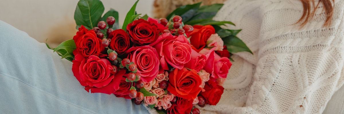 Vibrant red and pink roses beautifully arranged, creating a stunning floral display.