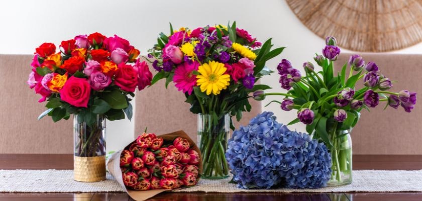 Vibrant floral arrangements featuring roses, tulips, and hydrangeas in elegant vases.