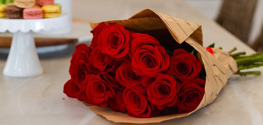 Freshly wrapped bouquet of vibrant red roses, perfect for expressing love and affection.