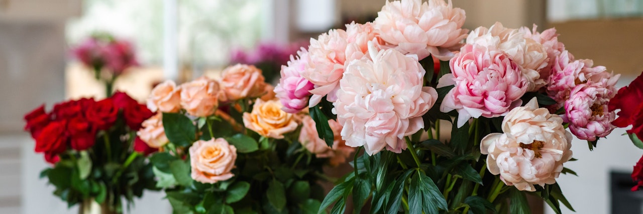 A vibrant assortment of roses and peonies in various colors, perfect for any celebration.