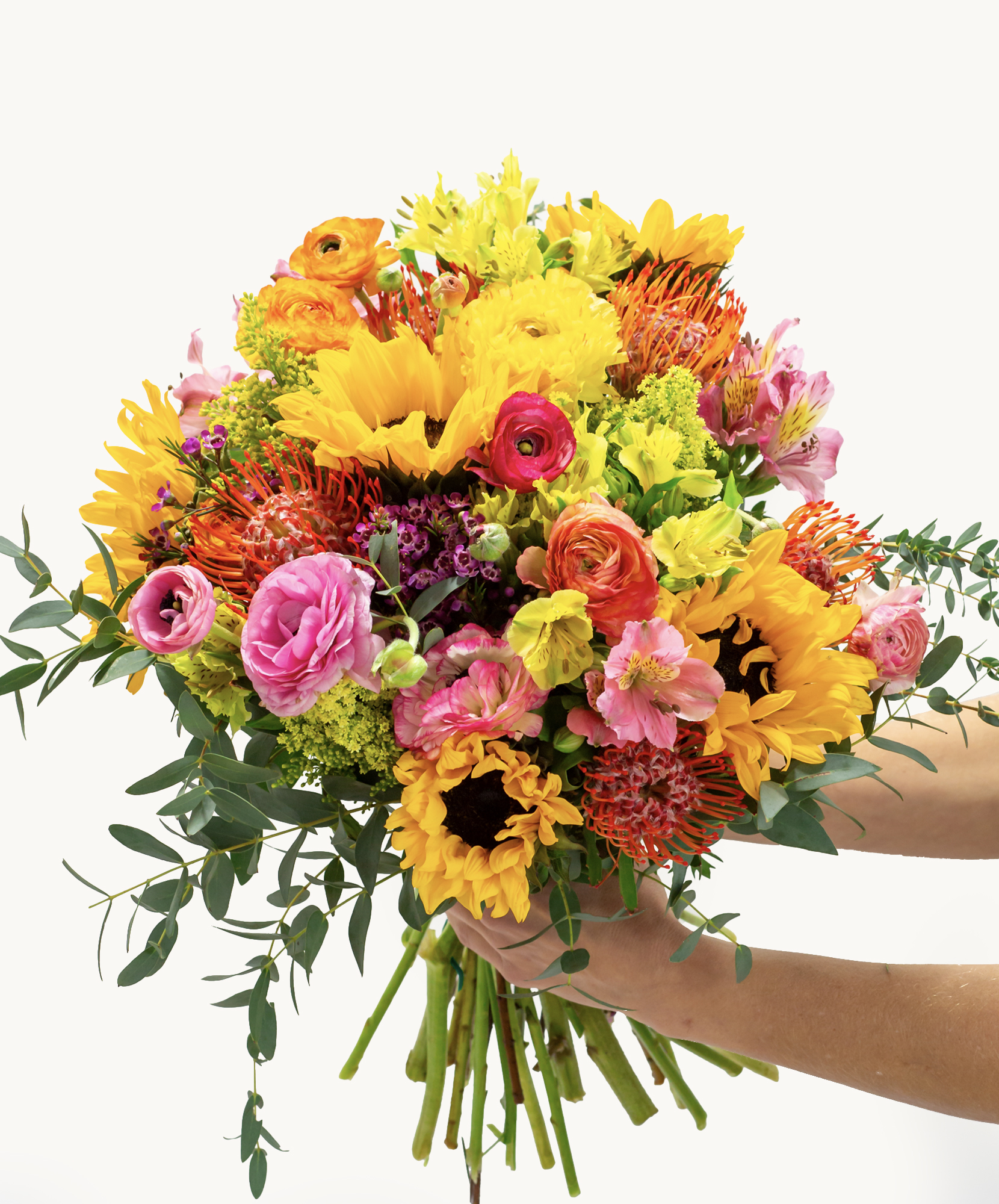 Vibrant bouquet featuring sunflowers, ranunculus, and colorful blooms, perfect for celebrations.