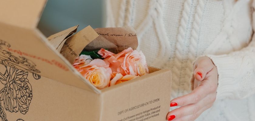 Delicate pastel roses nestled in a carefully crafted gift box, ready for delivery.
