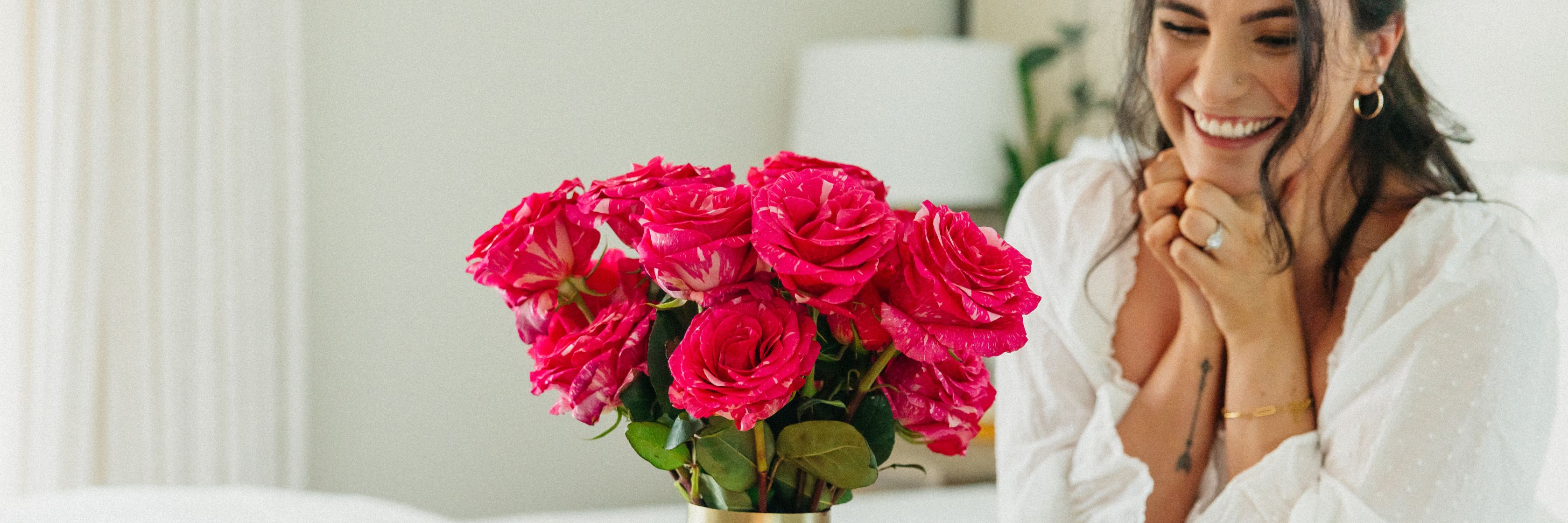 Vibrant pink roses in a stylish vase, bringing joy and beauty to any room setting.