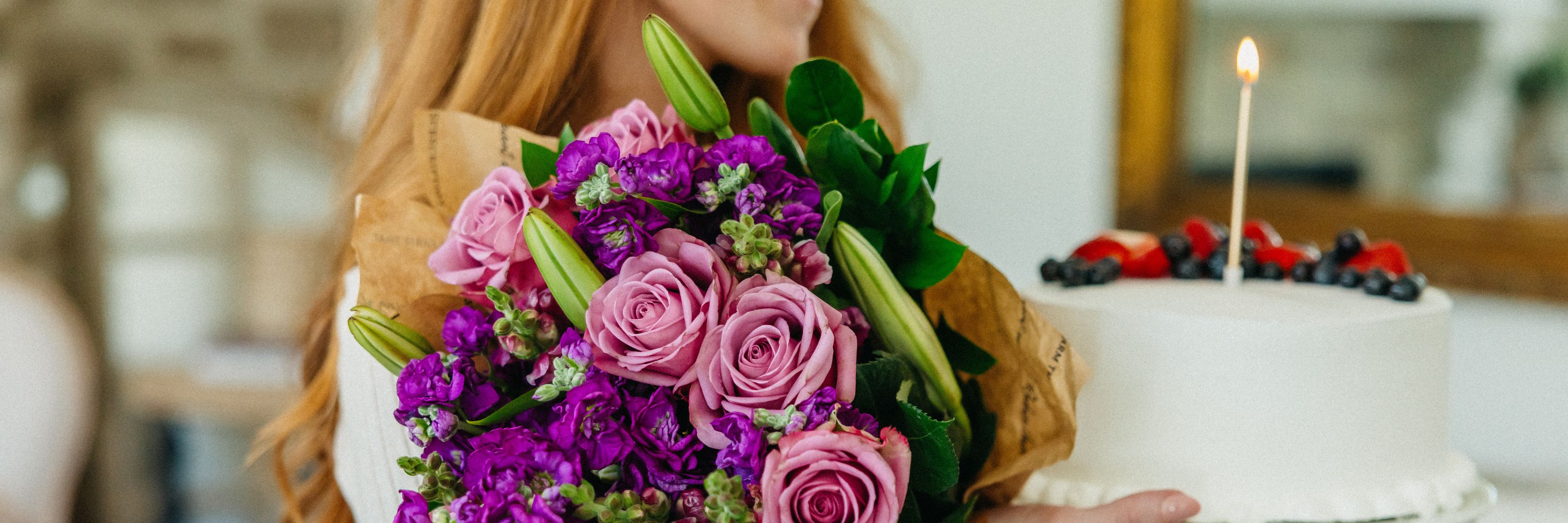 A vibrant bouquet of mixed flowers paired with a beautifully decorated birthday cake.