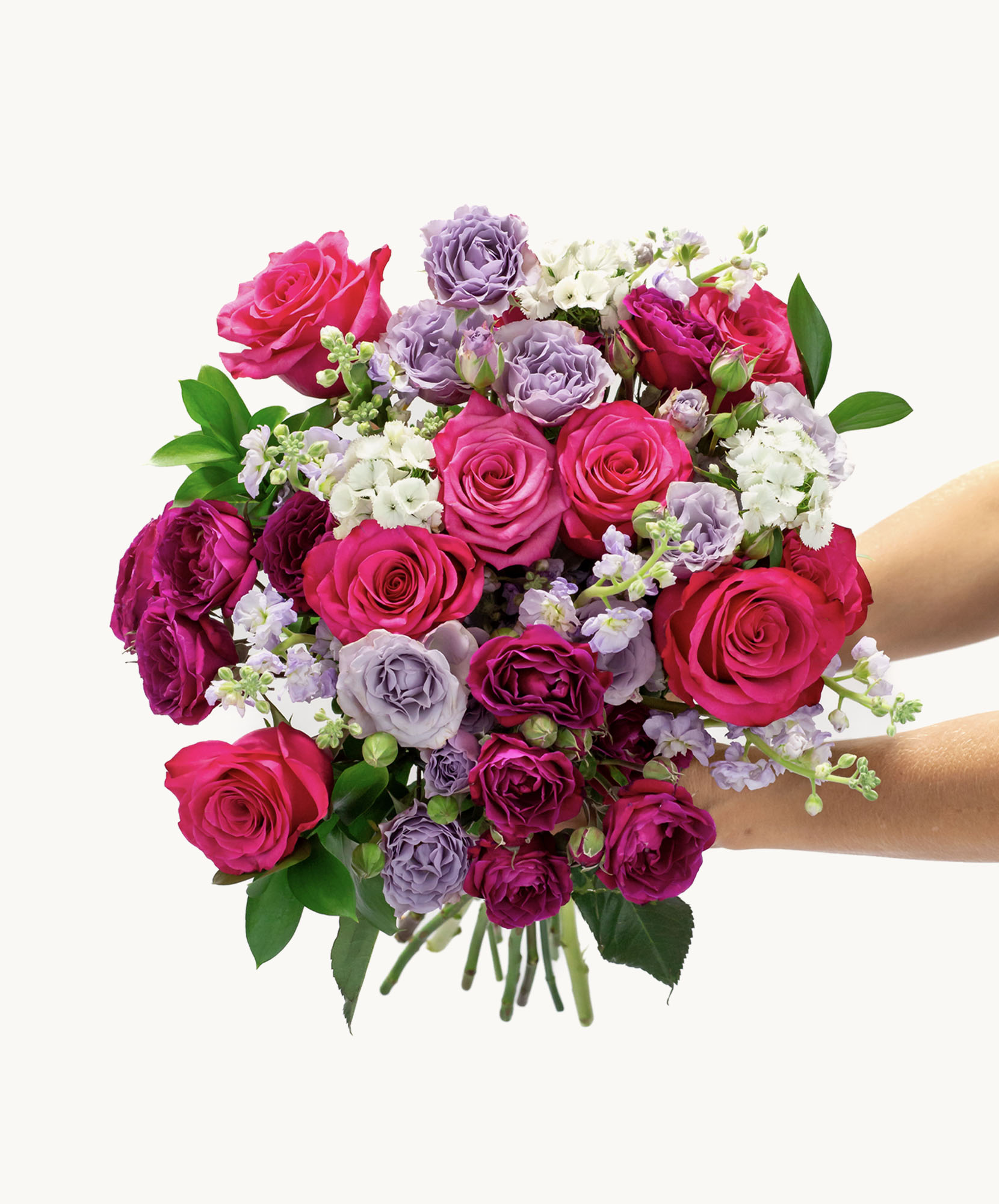 Vibrant bouquet featuring pink and purple roses, complemented by delicate white blooms.