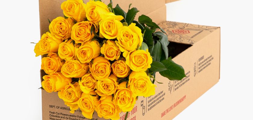 Vibrant bouquet of yellow roses elegantly arranged in a gift box for special celebrations.