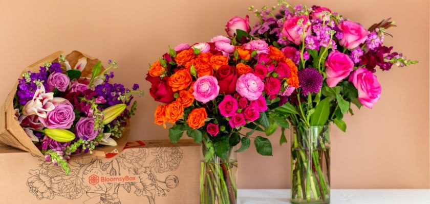 Vibrant floral arrangements featuring pink, orange, and purple blooms in elegant vases.
