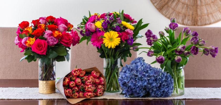 Vibrant flower arrangements featuring roses, tulips, and hydrangeas in stylish vases.