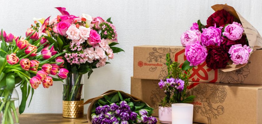 Vibrant assortment of floral bouquets with peonies, tulips, and roses in elegant packaging.