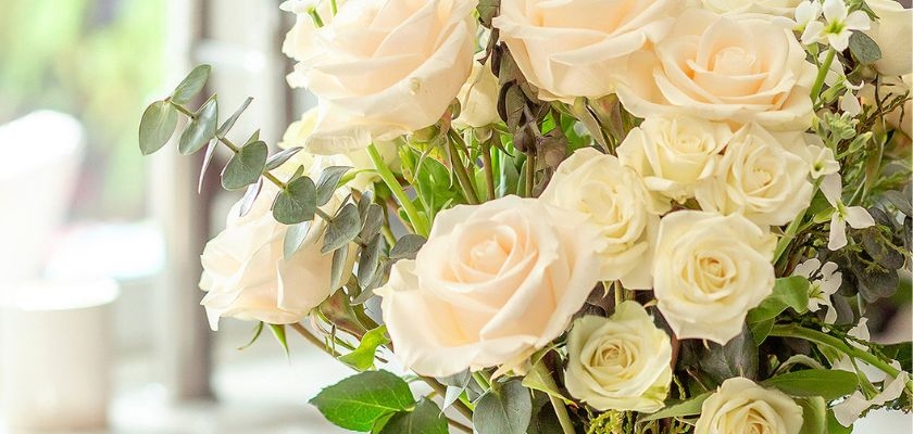 Beautiful arrangement of soft pink and white roses with fresh greenery, perfect for any occasion.