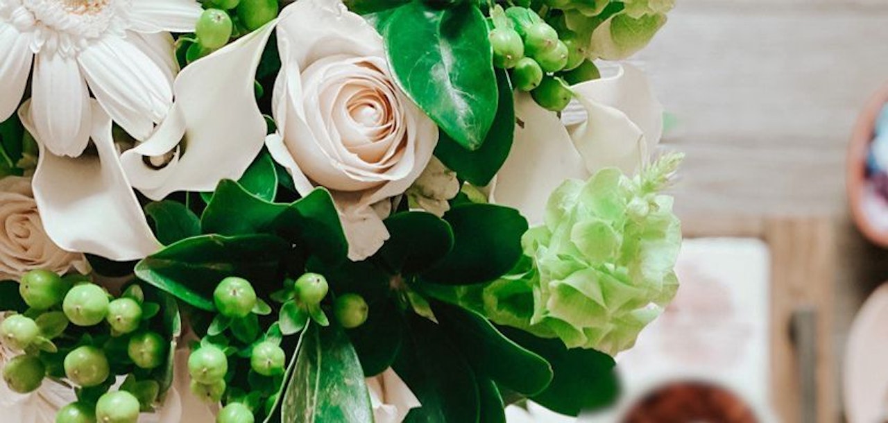 Elegant floral arrangement featuring soft roses, lush greens, and delicate blooms.