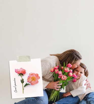 A joyful moment of a mother and daughter sharing a bouquet of pink tulips together.