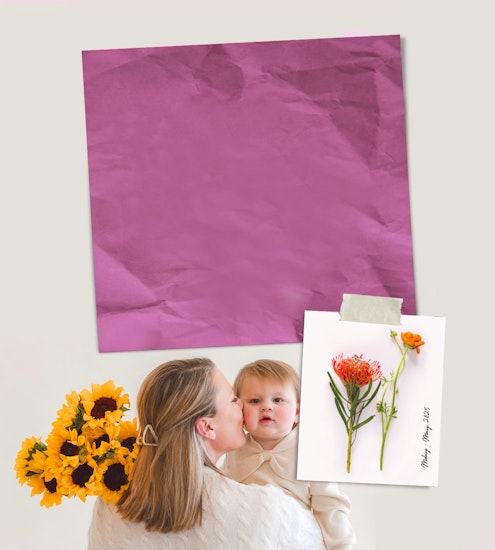 A mother gently kisses her child while holding a bouquet of vibrant sunflowers.