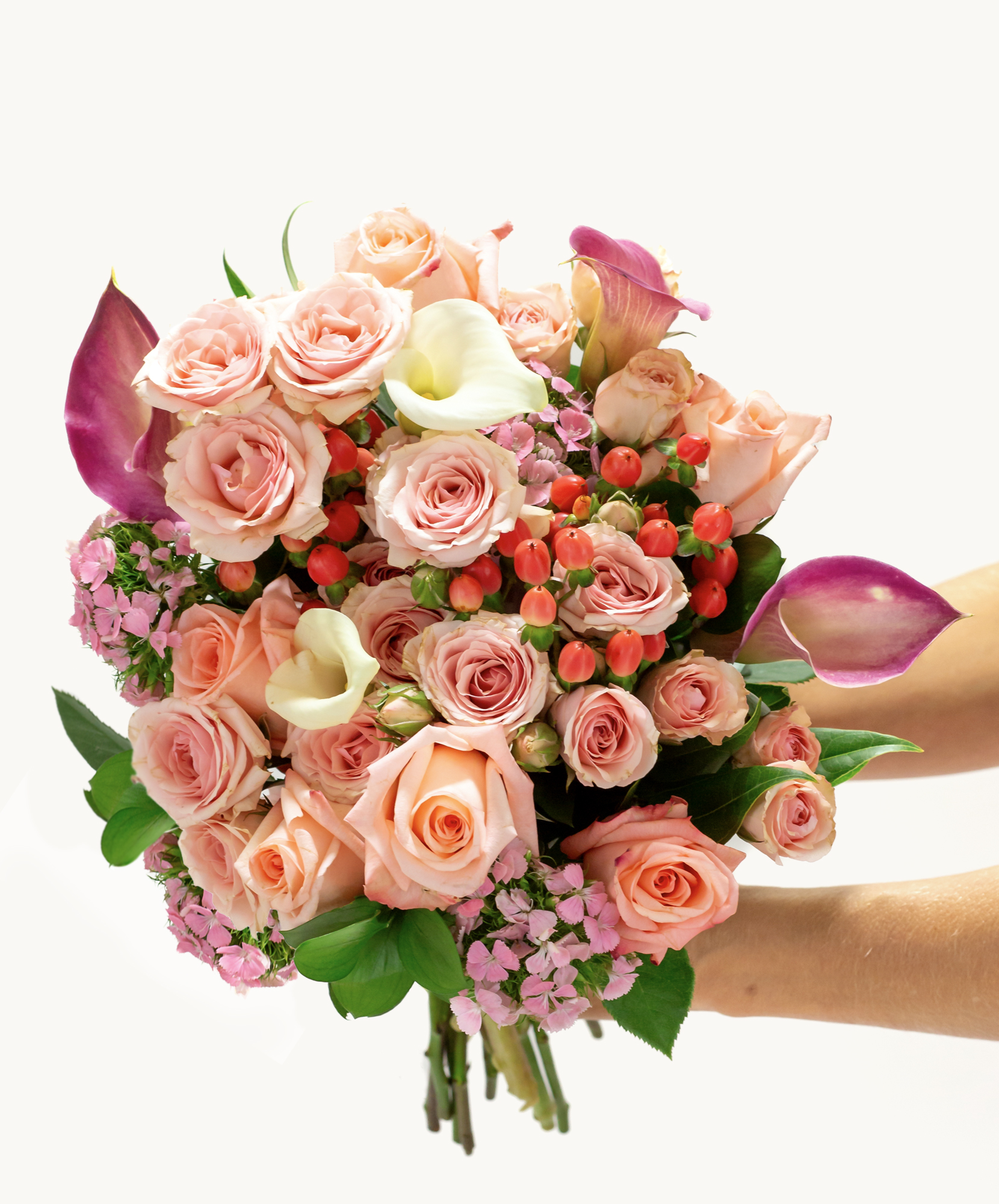Beautiful bouquet featuring pink roses, calla lilies, and seasonal blooms, perfect for celebrations.