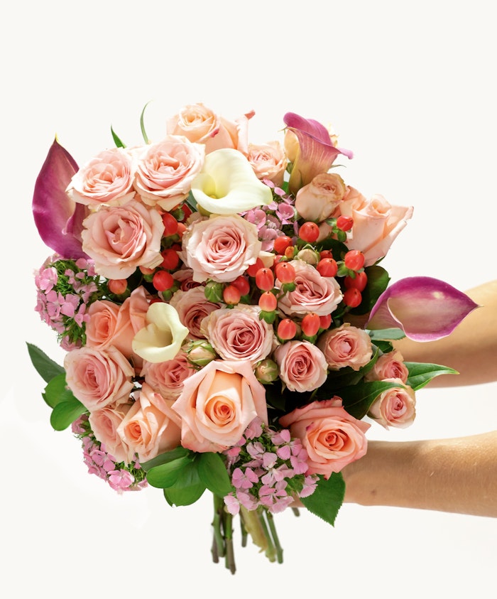 Beautiful bouquet featuring pink roses, calla lilies, and seasonal blooms, perfect for celebrations.
