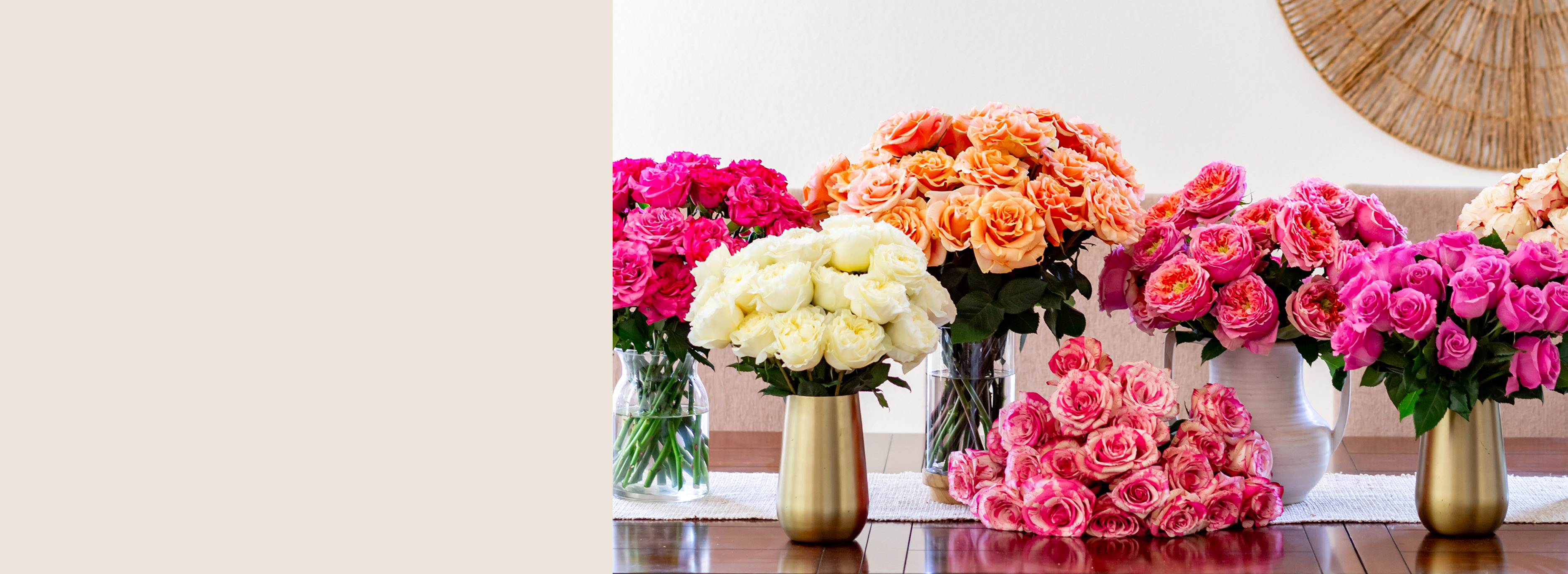 Vibrant floral display featuring pink, orange, and white roses in elegant vases.